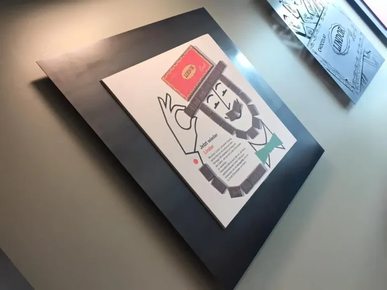 there are two framed pictures of a man with a book on the wall