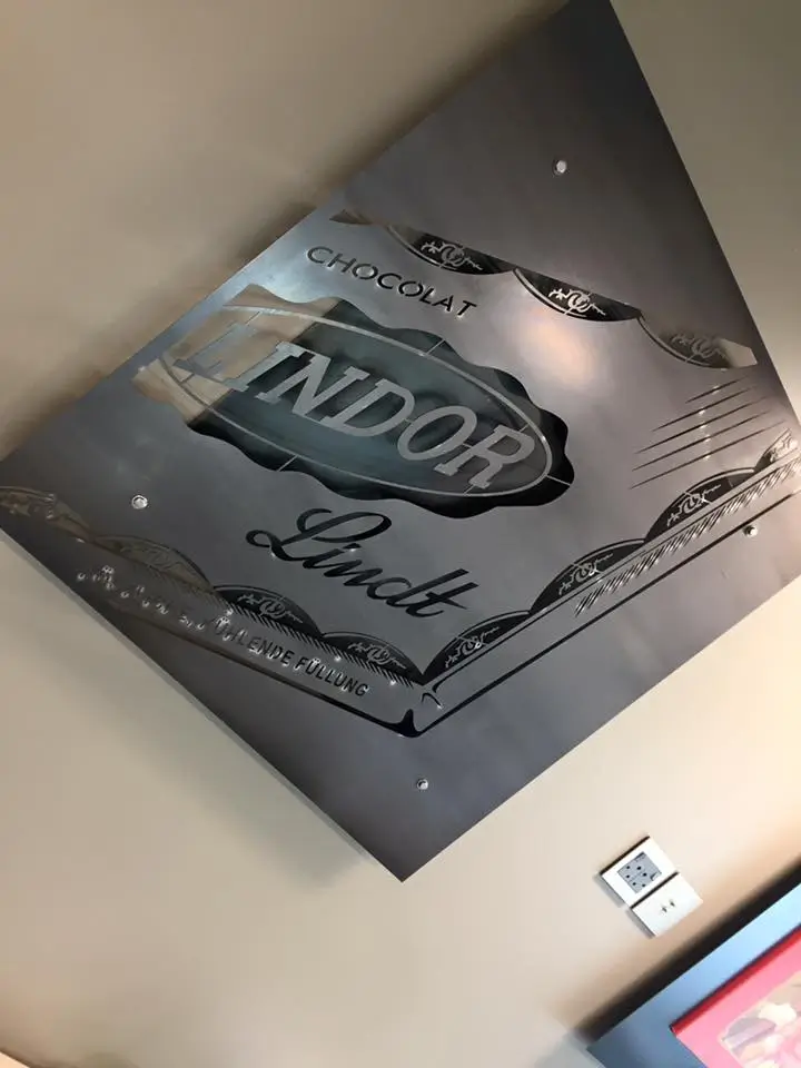 a close up of a sign on a wall above a table