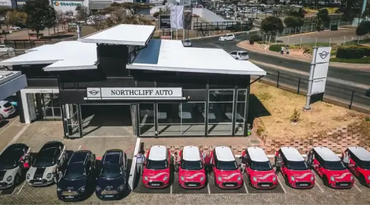 a close up of a parking lot with several cars parked in front of it