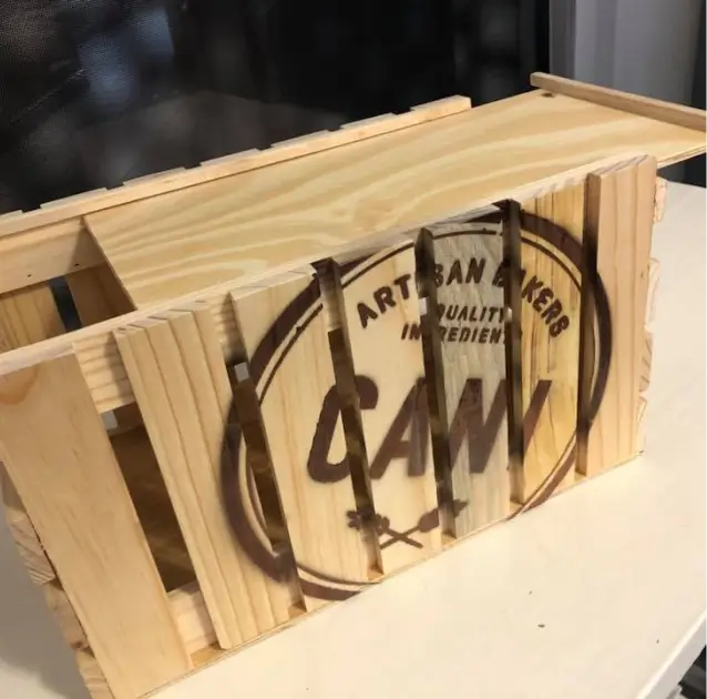 there is a wooden crate with a sign on it on a table