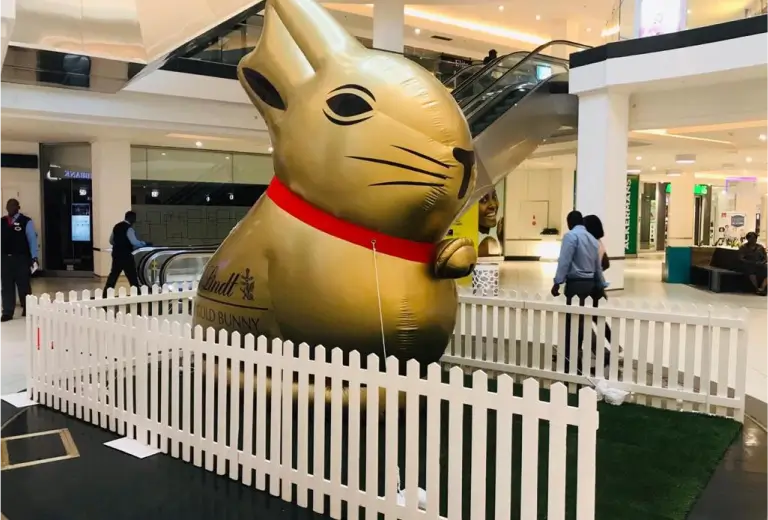 a close up of a giant inflatable cat in a mall