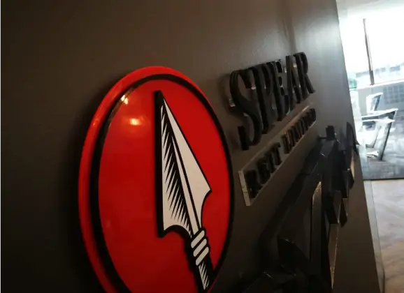 a close up of a sign on a wall with a knife on it