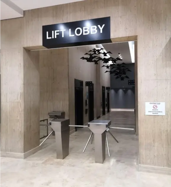 there is a large sign that says lift lobby above a table