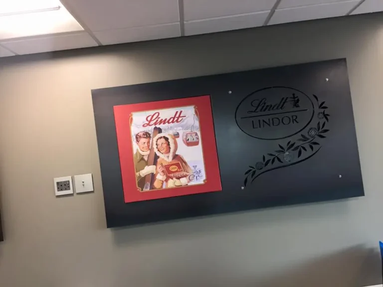 a close up of a wall with a sign and a picture of a woman