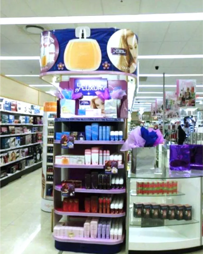 arafed display of cosmetics products in a store with a woman in the background