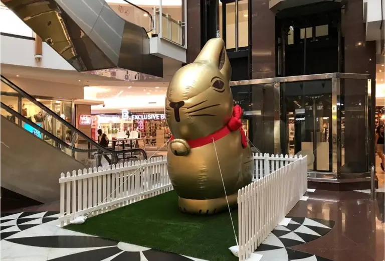 there is a giant inflatable cat in a shopping mall