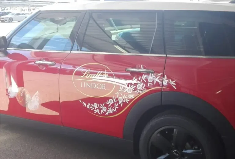 a close up of a red minivan with a white roof
