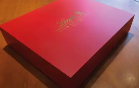 a close up of a red box on a wooden table
