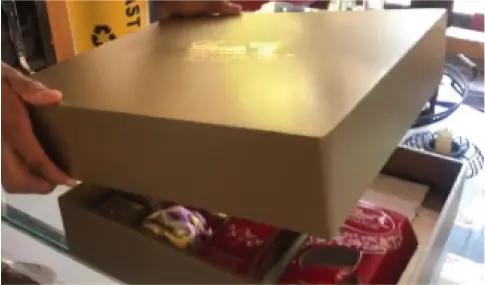 someone is opening a box with a lot of chocolates in it