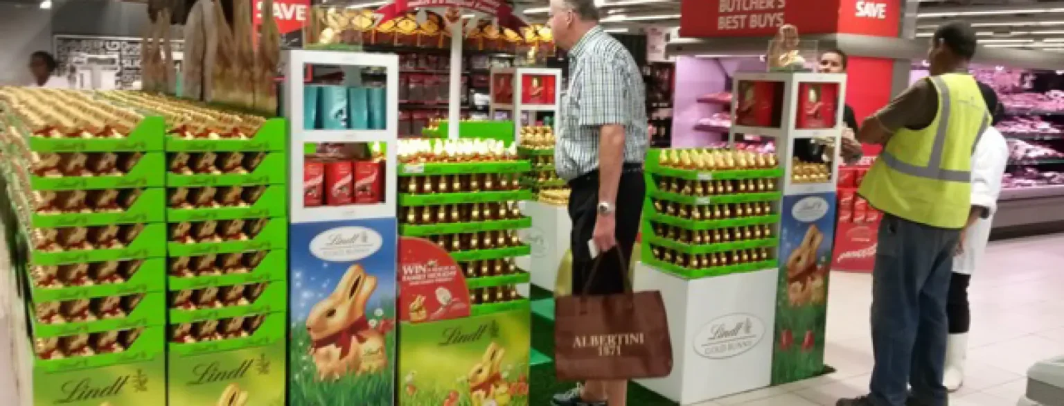 araffes in a store with a man standing next to a display of food