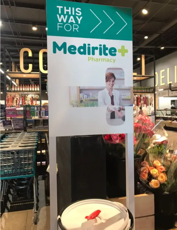 there is a sign that says medirie pharmacy in a store