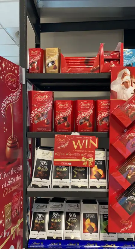 a close up of a shelf of chocolates and candy in a store