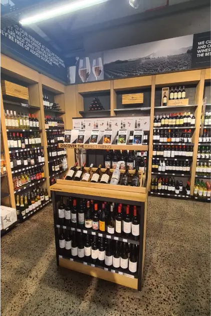 a close up of a wine store with a variety of bottles