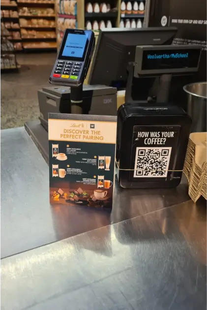 a close up of a counter with a phone and a barcode