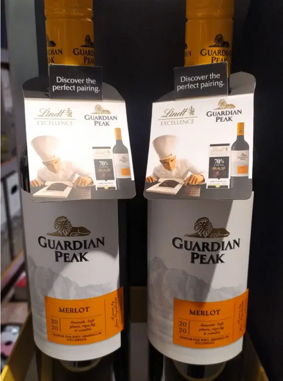 two bottles of wine are on display in a store