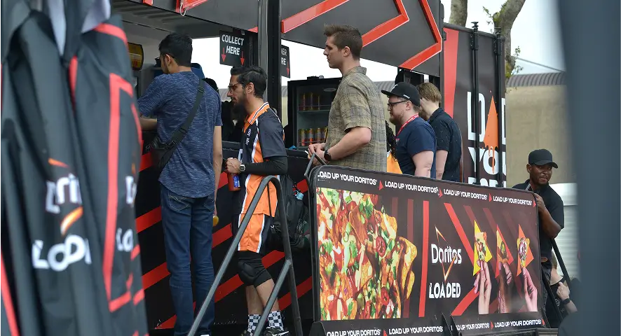 people standing in line at a fast food restaurant with a sign