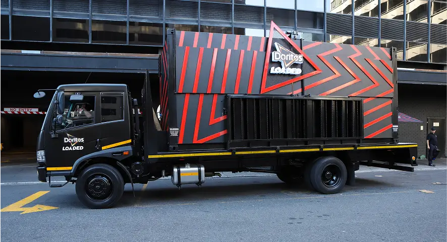 there is a black truck with a red and black design on it